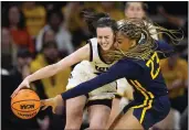  ?? CHARLIE NEIBERGALL — THE ASSOCIATED PRESS ?? West Virginia guard Lauren Fields (23) tries to steal the ball from Iowa guard Caitlin Clark in the first half of a second-round game in the NCAA Tournament on Monday, March 25, in Iowa City, Iowa.