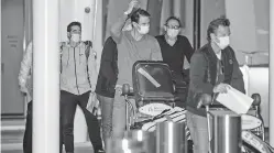  ?? MORGAN SETTE/AAP IMAGE VIA AP ?? Spain’s Rafael Nadal, center, arrives Thursday in Adelaide, Australia, ahead of the Australian Open. The tournament is set to start Feb. 8 in Melbourne.