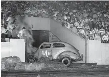  ?? CHICAGO TRIBUNE ARCHIVE ?? Roy Hupp, 58, and Arthur Eiberg, 56, were injured when a stock car driven by Harry Bennett, of Seattle, crashed through steel gates during a race program at Soldier Field on July 26, 1950. Hupp and Eiberg were standing behind the gates.