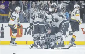  ?? Kelvin Kuo The Associated Press ?? The Los Angeles Kings celebrate the go-ahead goal by left wing Jeff Carter, bottom, in a 4-3 win Saturday over the visiting Knights.