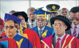  ?? AP ?? Zimbabwe's President Robert Mugabe (center) arrives to preside over a graduation ceremony.