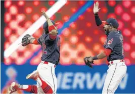  ?? RON SCHWANE/AP ?? Cleveland Indians Francisco Lindor, left, and Austin Jackson celebrate their victory over the Detroit Tigers on Tuesday night.