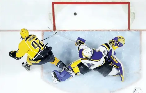  ?? MARK HUMPHREY/THE ASSOCIATED PRESS ?? Nashville Predators’ centre Ryan Johansen scores the game-winning goal against St. Louis Blues’ goalie Jake Allen during the third period in Game 6 of a second-round NHL hockey playoff series, on Sunday, in Nashville, Tenn. The Predators won 3-1 to win...