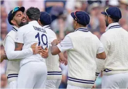  ?? — PTI ?? Indian skipper Virat Kohli with Umesh Yadav and other teammates celebrate after taking the wicket of England’s Dawid Malan on the second day of the Fourth Test match at The Oval in London on Friday. India ended the day at 43/0 in their second innings, after England were all out for 290. India is now trailing by 56 runs.
Report on Page 8