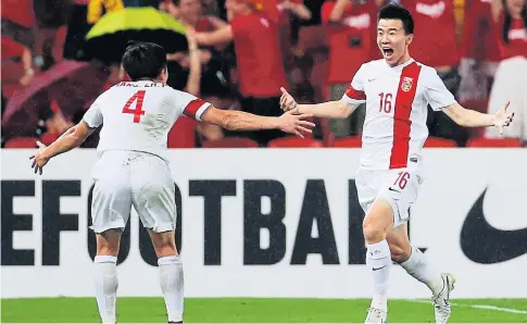  ?? REUTERS ?? China’s Sun Ke, right, celebrates with teammate Jiang Zhipeng after scoring the winner against Uzbekistan.