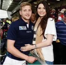  ??  ?? Model pro: Russell with girlfriend Mhairi Fergusson — the reigning Miss Scotland — after the Japan win
