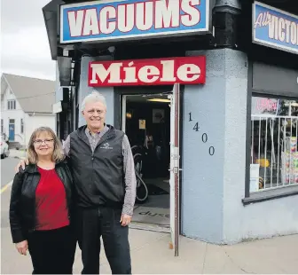  ?? ADRIAN LAM, TIMES COLONIST ?? Wendy and Byron Webb in front of their store All Victoria Vacuums on Hillside Avenue: “The hidden impacts of the current situation are the effects of our cutbacks on other local businesses.”