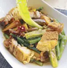  ??  ?? A local vegetable dish, pinakbet topped with lechon kawali or deep- fried pork belly