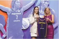  ?? ADAM HUNGER/ ASSOCIATED PRESS ?? Iowa’s Caitlyn Clark poses for a photo with WNBA commission­er Cathy Engelbert after being selected first overall by the Indiana Fever during the first round of the WNBA basketball on Monday in New York.