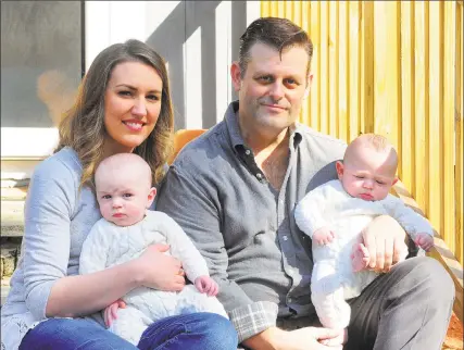  ?? Christian Abraham / Hearst Connecticu­t Media ?? Chris and Elizabeth Tillett pose with their twin sons John and Luke at their home in Wilton on Thursday. Doctors say Tillett, who was the first coronaviru­s patient in Connecticu­t, is no longer contagious and is able to be close with his family again.