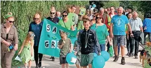  ??  ?? ●● The walk was to raise awareness of the plans to build on nearby green belt land