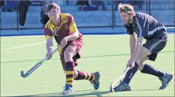  ??  ?? INTENSE: Royce Bennett of Warrack Hoops clears the ball despite pressure from Yanac Tigers’ Bradley Alexander during Wimmera Hockey Associatio­n’s open grand final at Dimboola. Picture: SIMON KING