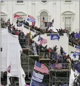  ?? PHOTOS BY THE ASSOCIATED PRESS ?? People shelter in the House gallery, above left, as protesters try to break into the House Chamber at the U.S. Capitol on Wednesday. Trump supporters gathered at the U.S. Capitol to protest the certificat­ion of President-elect Joe Biden’s win in November.