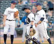  ?? NWA Democrat-Gazette file photo ?? Northwest Arkansas Naturals pitcher Josh Staumont (left) receives a visit from catcher Nick Dini and pitching coach Steve Luebber during last season’s Texas League North Division Series in Springdale. Beginning this season, Class AA clubs will be...