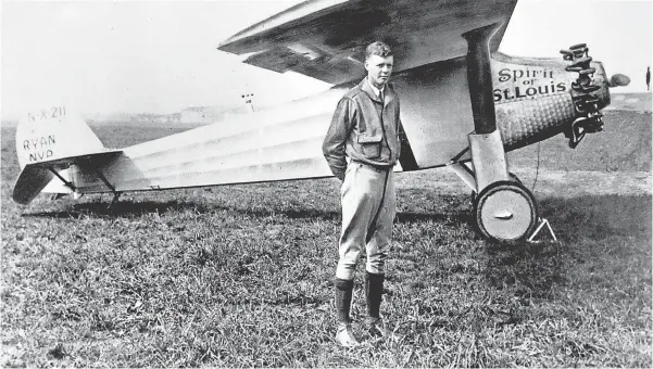  ?? 1927 FILE PHOTO BY AP ?? Charles A. Lindbergh poses with his plane, The Spirit of St. Louis. In 1927, Lindbergh made the first solo transatlan­tic flight, a 331⁄ 2- hour flight between North America and mainland Europe.