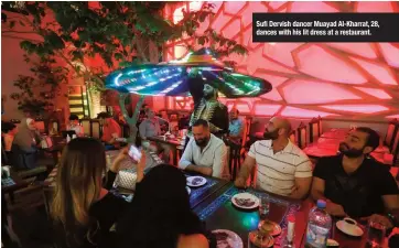  ??  ?? Sufi Dervish dancer Muayad Al-Kharrat, 28, dances with his lit dress at a restaurant.