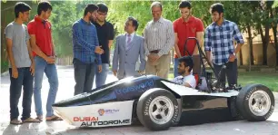  ?? Photo by Juidin Bernarrd ?? Gear Shifters, the students who designed the UaE’s first formula 1 student race car, and their professors with the vehicle. The car will be showcased at formula SaE in Germany next year and the dubai motor Show this year. —