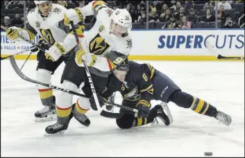  ?? Adrian Kraus The Associated Press ?? Golden Knights left wing Tomas Nosek (92) tries to get by Buffalo Sabres defenseman Casey Nelson (8) early in a 2-1 shootout victory Saturday.