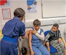  ?? ANDREW TESTA/THE NEW YORK TIMES ?? People are treated Feb. 16 at a pop-up vaccine clinic in Wolverhamp­ton, England.