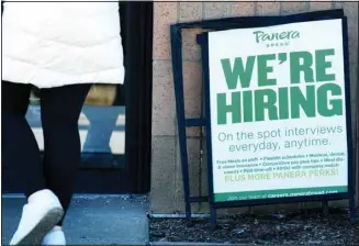  ?? ?? A hiring sign is displayed at a restaurant in Mount Prospect, Ill., Sunday, March 19, 2023. On Thursday, the Labor Department reports on the number of people who applied for unemployme­nt benefits last week. (AP)