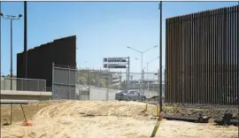  ?? Nelvin C. Cepeda San Diego Union-Tribune ?? SHOWN in September, the $18-million project replaced a corrugated steel fence in Calexico with 30-foot bollards that allow agents to see through to the other side.