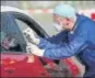  ?? AFP ?? A German doctor swabs the throat of a car driver through the window on Saturday.