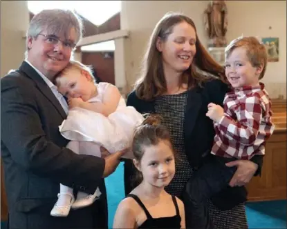  ??  ?? The Emerson family: Howie, Anna and children Grace, James and Katie, on the occasion of Katie’s baptism.