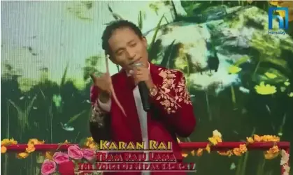  ?? Photograph: Silver Entertainm­ent ?? A screen capture of a telecast showing Karan Rai, of Louisville, Kentucky, singing on the Nepali version of the Voice.