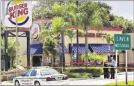 ?? LANNIS WATERS / THE PALM ?? Palm Beach County Sheriff’s Office investigat­ors gather evidence at the Burger King on the 200 block of North Dixie Highway in Lake Worth after a shooting in September.