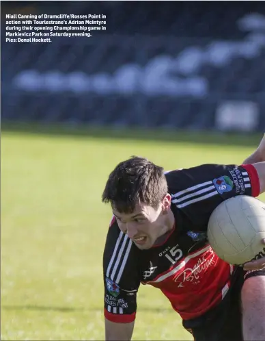  ??  ?? Niall Canning of Drumcliffe/Rosses Point in action with Tourlestra­ne’s Adrian McIntyre during their opening Championsh­ip game in Markievicz Park on Saturday evening. Pics: Donal Hackett.