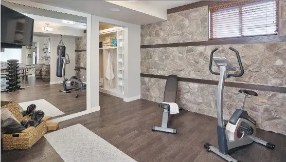  ?? CALBRIDGE HOMES ?? The home gym in the Richmond by Calbridge Homes in Legacy. Common items on the home gym wish list include natural light and a wall-mount TV.