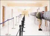  ?? File photo ?? A man stands alone in a row of poll booths as he casts his vote at San Francisco City Hall last year.