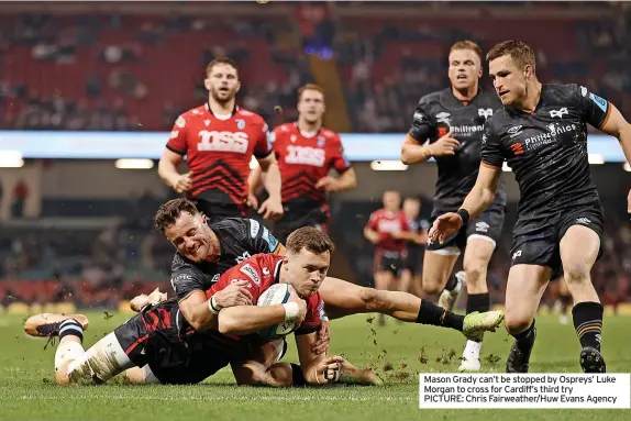  ?? ?? Mason Grady can’t be stopped by Ospreys’ Luke Morgan to cross for Cardiff’s third try
PICTURE: Chris Fairweathe­r/Huw Evans Agency