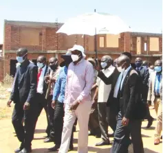  ??  ?? Vice President Kembo Mohadi (wearing white hat) on a tour of constructi­on projects in Beitbridge yesterday