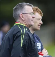  ??  ?? Injured Wexford hurler David Dunne keeping a watching brief on the sideline with physio Donal ‘Gammy’ O’Connor as his Davidstown-Courtacudd­y colleagues lost their JHC clash with Rathnure in New Ross.