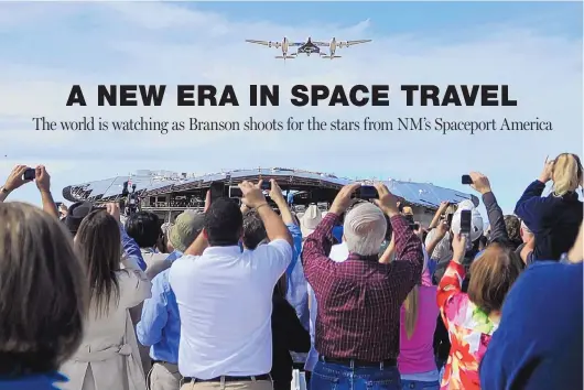  ?? ROBERTO E. ROSALES/JOURNAL ?? Spectators take photos of Virgin Galactic’s White Knight Two spaceship during a 2010 runway dedication at Spaceport America. The unfinished spaceport is visible in the background.