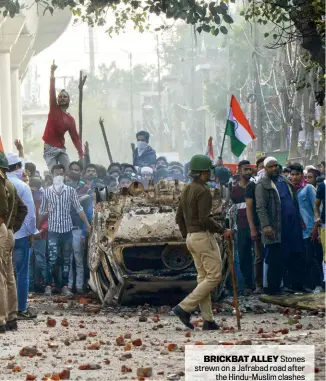  ??  ?? BRICKBAT ALLEY Stones strewn on a Jafrabad road after the Hindu-Muslim clashes