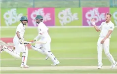  ??  ?? Pakistani batsmen Babar Azam (L) and Yasir Shah (C) run between wickets next to New Zealand bowler Neil Wagner during the second day of the first Test cricket match between Pakistan and New Zealand at the Sheikh Zayed Internatio­nal Cricket Stadium in Abu Dhabi on November 17, 2018. - AFP photo