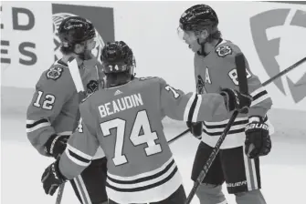  ?? NAM Y. HUH/AP ?? Patrick Kane (right, with Alex DeBrincat and Nicolas Beaudin) had a goal and three assists Tuesday in a 6-5 shootout victory against the Blue Jackets. Kane is two goals shy of 400 for his career.