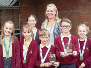  ??  ?? ●● Teacher Jenny Myers with the winning gymnasts from Lostock Hall Primary School
