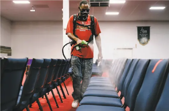  ?? Photos by Michael Short / Special to The Chronicle ?? Maintenanc­e technician James Williams shows how he uses an electrosta­tic sprayer to disinfect seats at Acts Full Gospel Church of God in Christ in Oakland.