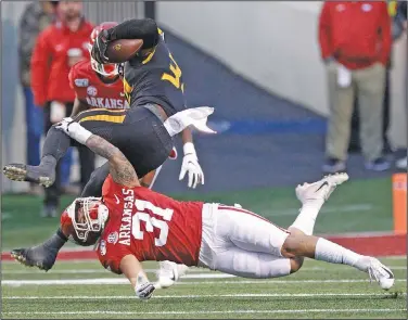  ?? Thomas Metthe/Arkansas Democrat-Gazette ?? Tripped up: Arkansas linebacker Grant Morgan (31) trips up Missouri running back Larry Rountree III (34) during the fourth quarter of the Razorbacks' 24-14 loss to Missouri in 2019 at War Memorial Stadium in Little Rock.