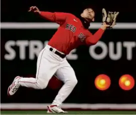  ?? JIM DAVIS/GLOBE STAFF ?? Red Sox left fielder Rob Refsnyder (above) kept looking skyward after catching a Matt Chapman fly ball in the first.