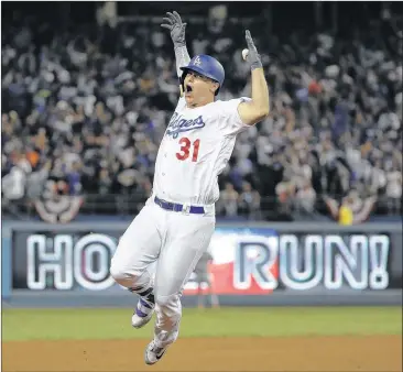  ?? AP ?? Joc Pederson rejoices after extending the Dodgers’ lead to 3-1 with a solo home run in the seventh inning Tuesday night. L.A. held on to force Game 7 at Dodger Stadium. Subscriber­s can find the late result in today’s ePaper.