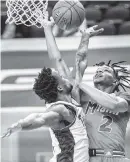  ?? WOODY MARSHALL, NEWS & RECORD Woody Marshall ?? Miami’s Isaiah Wong puts up a shot as Femi Odukale defends for Pittsburgh on Tuesday. The Hurricanes played an inspired game and will face Clemson on Wednesday in the second round.