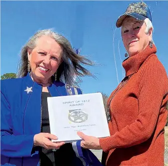  ?? Submitted photo ?? Sheila Beatty-Krout, right, on behalf of state Chairman Mary-Reid Warner, met with outgoing state President Kay Tatum and presented her with her nomination packet book and the national Spirit of 1812 Medallion.