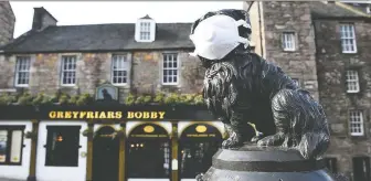  ?? ANDY BUCHANAN/GETTY IMAGES ?? Greyfriars Bobby is famous for having guarded the grave of its deceased owner for 14 years until the dog's death in 1872. The statue is a tourist attraction in the centre of Edinburgh.