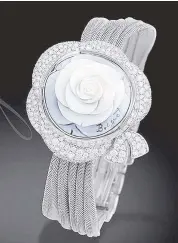  ??  ?? High Jewellery Secret de la Reine selfwindin­g wristwatch in 18K white gold: Hand-sculpted cameo floral decoration reveals the dial and its bow motif paved with 596 diamonds.