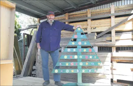  ??  ?? Enjoying the gift of giving . . . Des Crichton with a Christmas tree he made at the Men’s Shed.