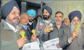  ?? HT PHOTO ?? Shiromani Akali Dal leader Bikram Singh Majithia and other legislator­s shaking rattles after staging a walkout from the Vidhan Sabha on Thursday.